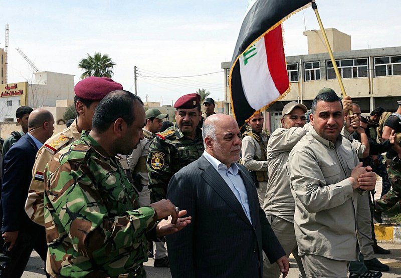 Iraqi Prime Minister Haider al-Abadi tours the city of Tikrit after it was retaken by the security forces in Baghdad, Iraq, Wednesday, April 1, 2015. Iraq declared a "magnificent victory" over the Islamic State group in Tikrit, a key step in driving the militants out of their biggest strongholds.