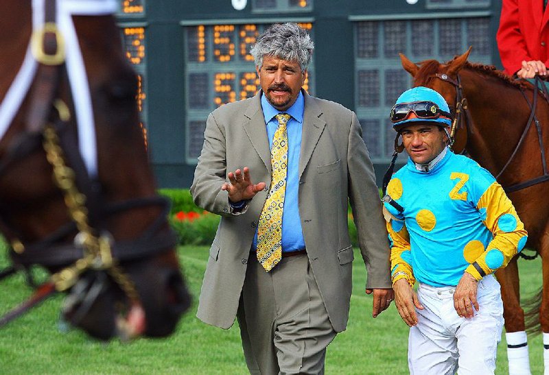Trainer Steve Asmussen talks with Jockey Corey Nakatani, right, in the infield at Oaklawn Park in this file photo.