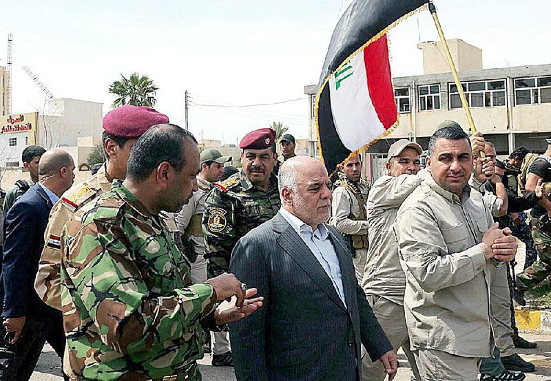 Iraqi Prime Minister Haider al-Abadi tours Tikrit on Wednesday after security forces took the city back from Islamic State militants.