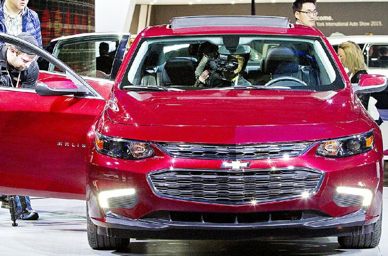 A videographer photographs a 2016 Chevrolet Malibu hybrid on Wednesday at the New York International Auto Show. U.S. auto dealers sold 1.5 million new cars and trucks in March.