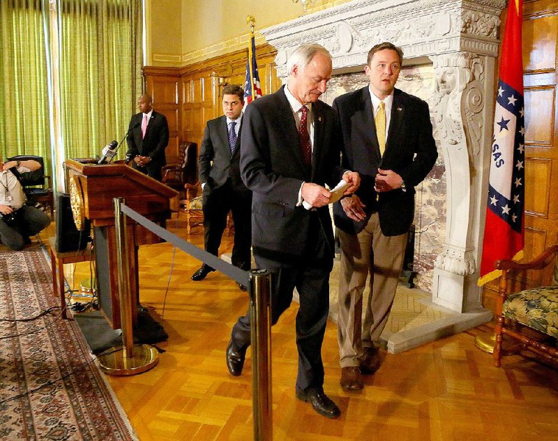 Gov. Asa Hutchinson (center) leaves a news conference Wednesday at the Capitol with Senate President Pro Tempore Jonathan Dismang (left) and House Speaker Jeremy Gillam after calling on lawmakers to make changes to the Religious Freedom Restoration Act.  