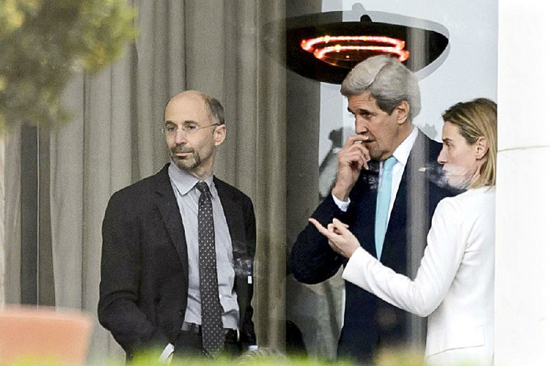 Secretary of State John Kerry (center) confers with U.S. negotiator Robert Malley and Federica Mogherini of the European Union during a break in talks Wednesday in Lausanne, Switzerland. 