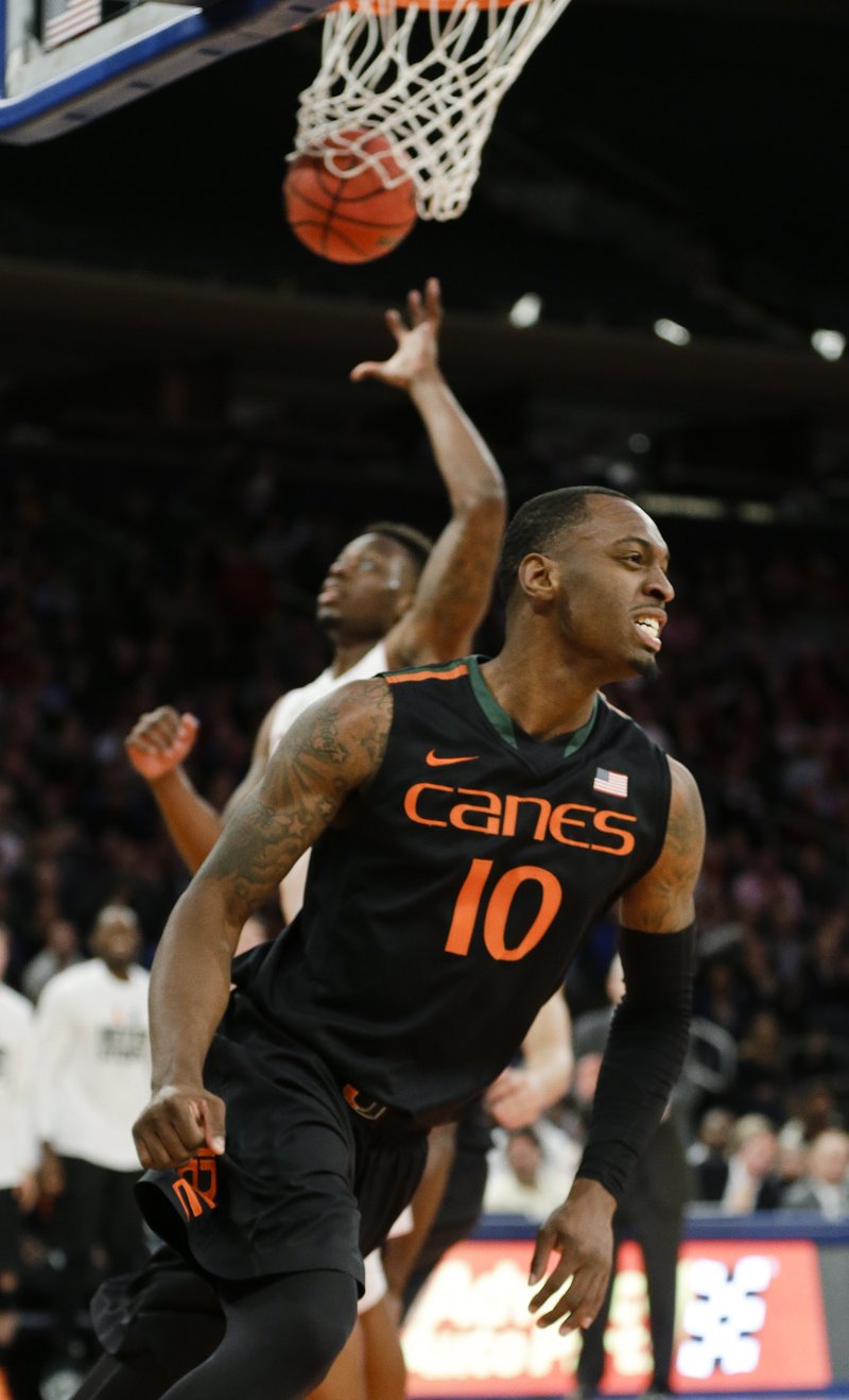 Miami's Sheldon McClellan (10) reacts after scoring as Temple's Quenton DeCosey (25) reaches for the ball during the second half of a semifinal at the NIT college basketball tournament Tuesday, March 31, 2015, in New York. Miami won 60-57.