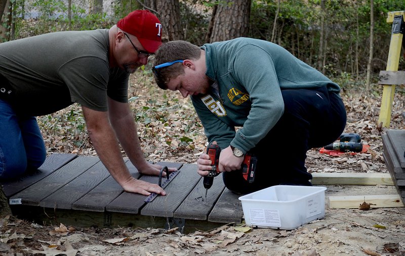 Ronald Culver builds a walking bridge under construction in the South Arkansas Arboretum State Park for his Eagle Scout project. Culver received help from his step-dad, Allen Williams, and guidance from the South Arkansas Community College maintenance crew. SACC maintenance workers will replace other bridges in need of work in the arboretum after Culver completes his project.