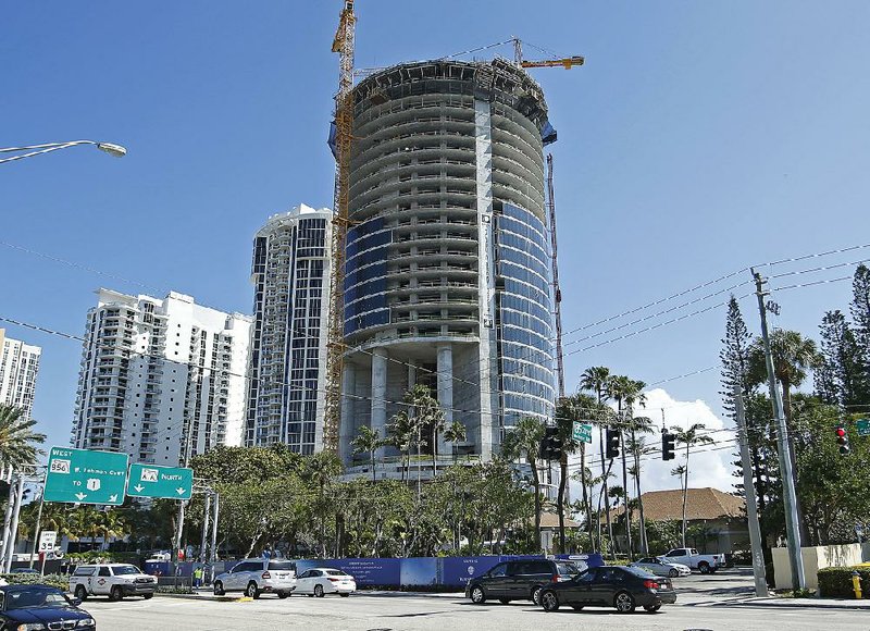 The Porsche Design Tower is under construction in Sunny Isles Beach, Fla. With a slew of residential and hotel developments, Miami is embracing the notion that homes, like cars, handbags and jewelry, should carry luxe designer labels. 