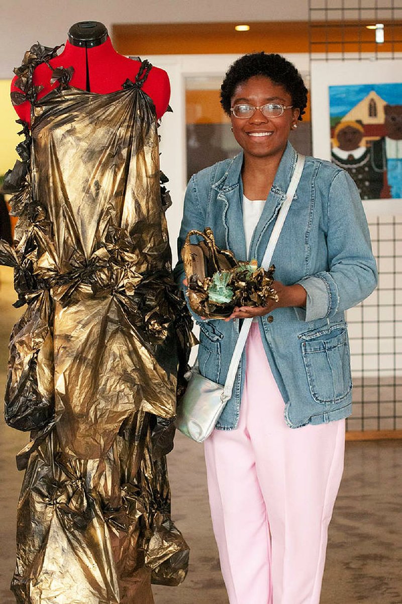 Ashayla Burnett of eStem Public Charter School in Little Rock shows off a dress she designed from garbage bags. Burnett took second place and got a $2,500 scholarship in Thea Foundation’s second Fashion Design Scholarship Competition.