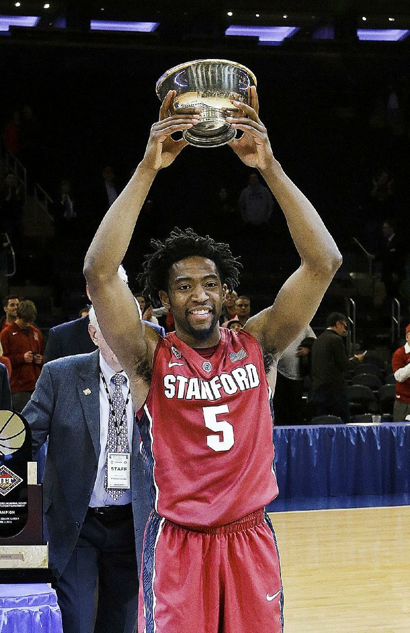 Stanford's Chasson Randle poses for a photographs with the most outstanding player trophy after the championship game against Miami at the NIT college basketball tournament Thursday, April 2, 2015, in New York. Stanford won 66-64 in overtime. (AP Photo/Frank Franklin II)