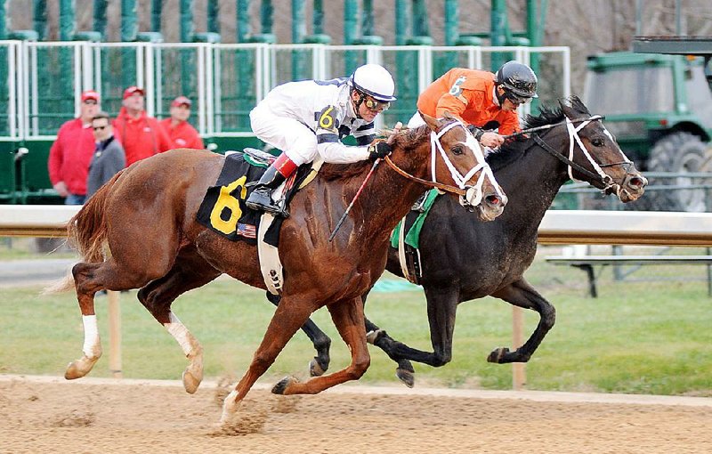 Take Charge Brandi (6) with jockey Jon Court aboard, holds off Sarah Sis (5) and Julio Felix to win the Martha Washington Stakes on Jan. 31 at Oaklawn Park in Hot Springs. 