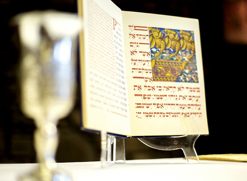 A Haggadah, a Jewish text that sets forth the order of the seder, is set on display at the Lost Bridge Community Center in Garfield. Shoshanna Weinisch, a missionary with Jews for Jesus, on Monday explained the Passover seder in her tradition for members of Lost Bridge Village Community Church.