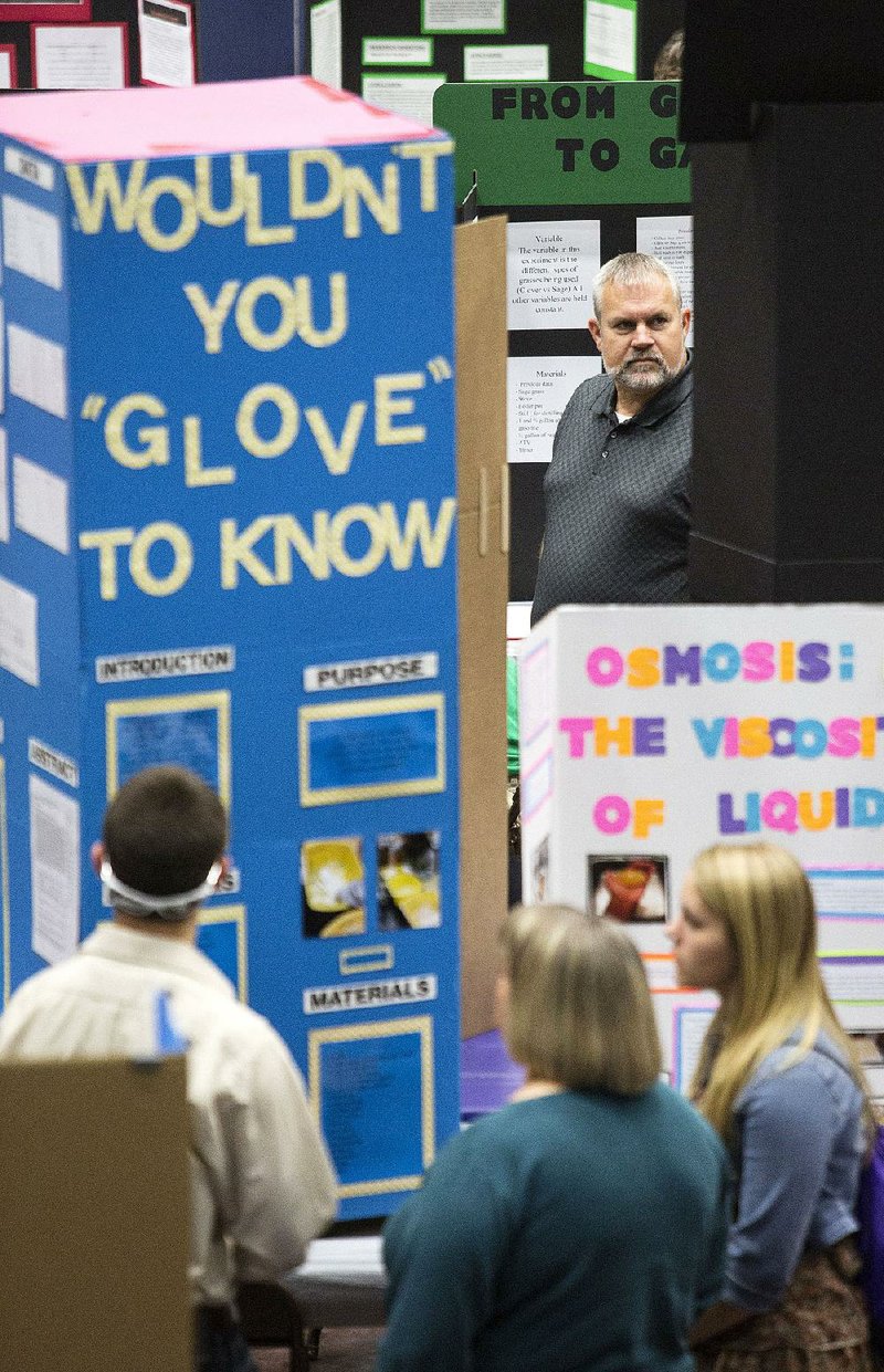 Donnie Earnest (top) of Glen Rose peruses displays of science projects Saturday at the University of Central Arkansas in Conway.