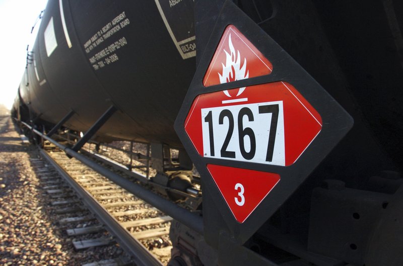 AP/MATTHEW BROWN A warning placard is displayed on a tank car carrying crude oil near a loading terminal in Trenton, N.D. In new rules that went into effect last week, North Dakota is requiring oil companies to reduce the volatility of crude before it&#8217;s loaded onto rail cars.