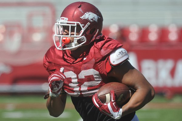 Arkansas running back Jonathan Williams runs drills during practice Saturday, April 4, 2015, at Razorback Stadium in Fayetteville.