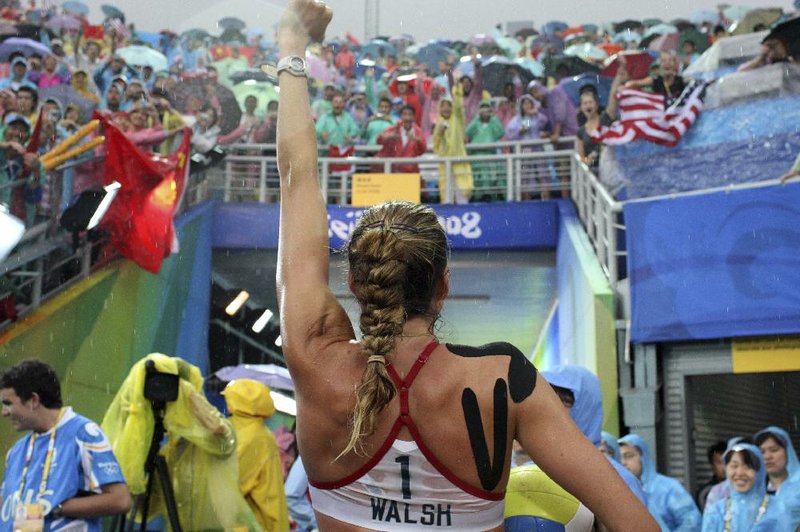FILE -- Kerri Walsh, of the U.S., wearing kinesiology tape at the 2008 Olympics in Beijing, Aug. 21, 2008. Kinesiology tape is the thin, stretchy fabric in bright colors that you see athletes wearing these days, but the purported benefits are largely unsubstantiated. (Doug Mills/The New York Times)