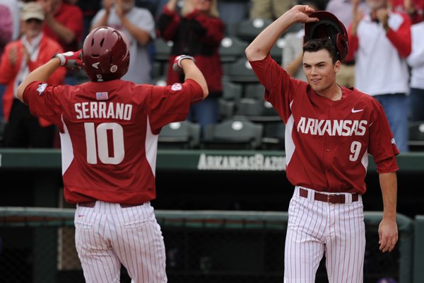 Joe Serrano (10) of Arkansas is congratulated at the plate by Clark Eagan after Serrano hit a 2-run home run against LSU during the seventh inning Saturday, March 21, 2015, at Baum Stadium in Fayetteville. Visit nwadg.com/photos for more photos from the game.
