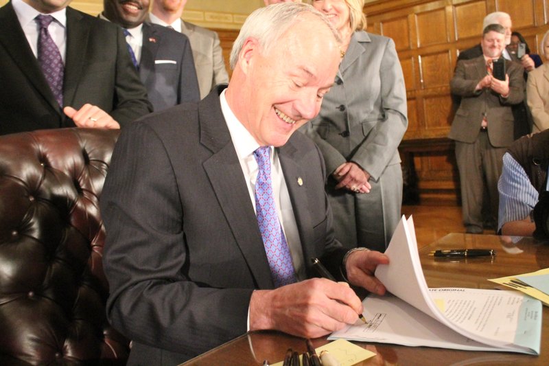 Gov. Asa Hutchinson signs Senate Bills 891, 368 and 791 for his workforce initiative into law Monday, April 6, 2015. 