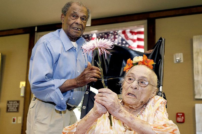 Gertrude Weaver, right, talks with her son Joe Weaver, Thursday, July 3, 2014 at Silver Oaks Health and Rehabilitation Center in Camden, Ark., a day before her 116th birthday. The Gerontology Research Group says Weaver is the oldest person in the United States and second-oldest person in the world. (AP Photo/Danny Johnston)