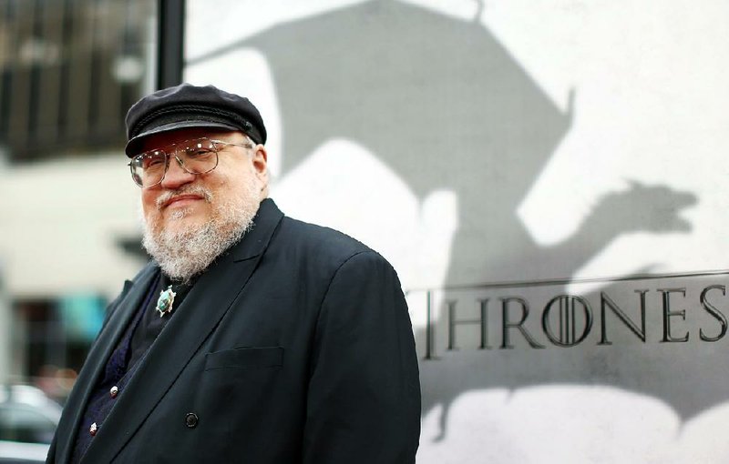 FILE - In this March 18, 2013 file photo, author George R.R. Martin arrives at the premiere for the third season of the HBO television series "Game of Thrones" at the TCL Chinese Theatre in Los Angeles. "The World of Ice & Fire: The Untold History of Westeros and the Game of Thrones," a companion volume to Martin's "Ice and Fire" series, will be released Tuesday, Oct. 28, 2014. (Photo by Matt Sayles /Invision/AP, File)