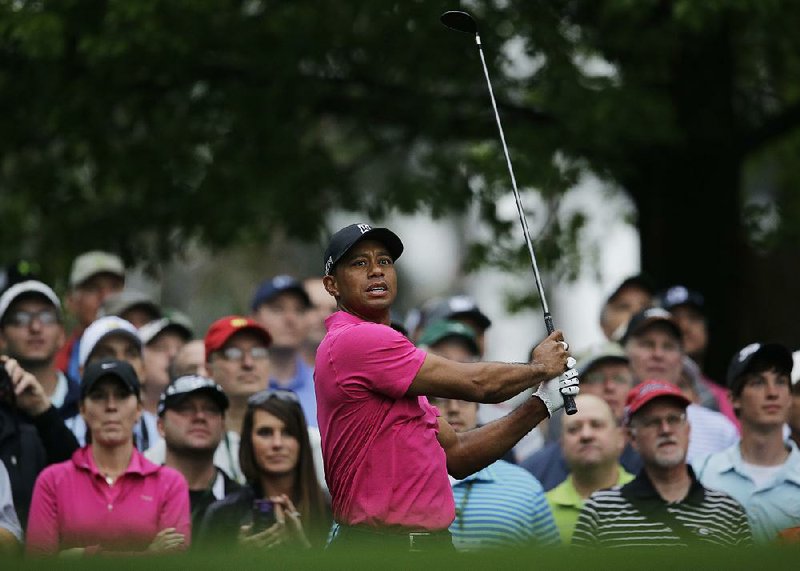 Tiger Woods watches his tee shot on the fourth hole during a practice round for the Masters golf tournament Tuesday, April 7, 2015, in Augusta, Ga. 