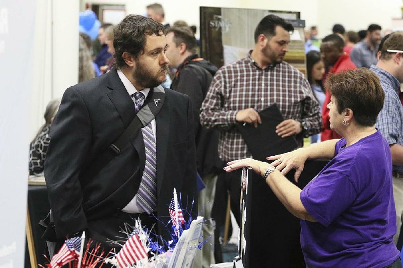 Nathan Golder (left) speaks with Deborah Kelley, with the Georgia National Guard Family Assistance Center, during a job fair Thursday in Ringgold, Ga. 