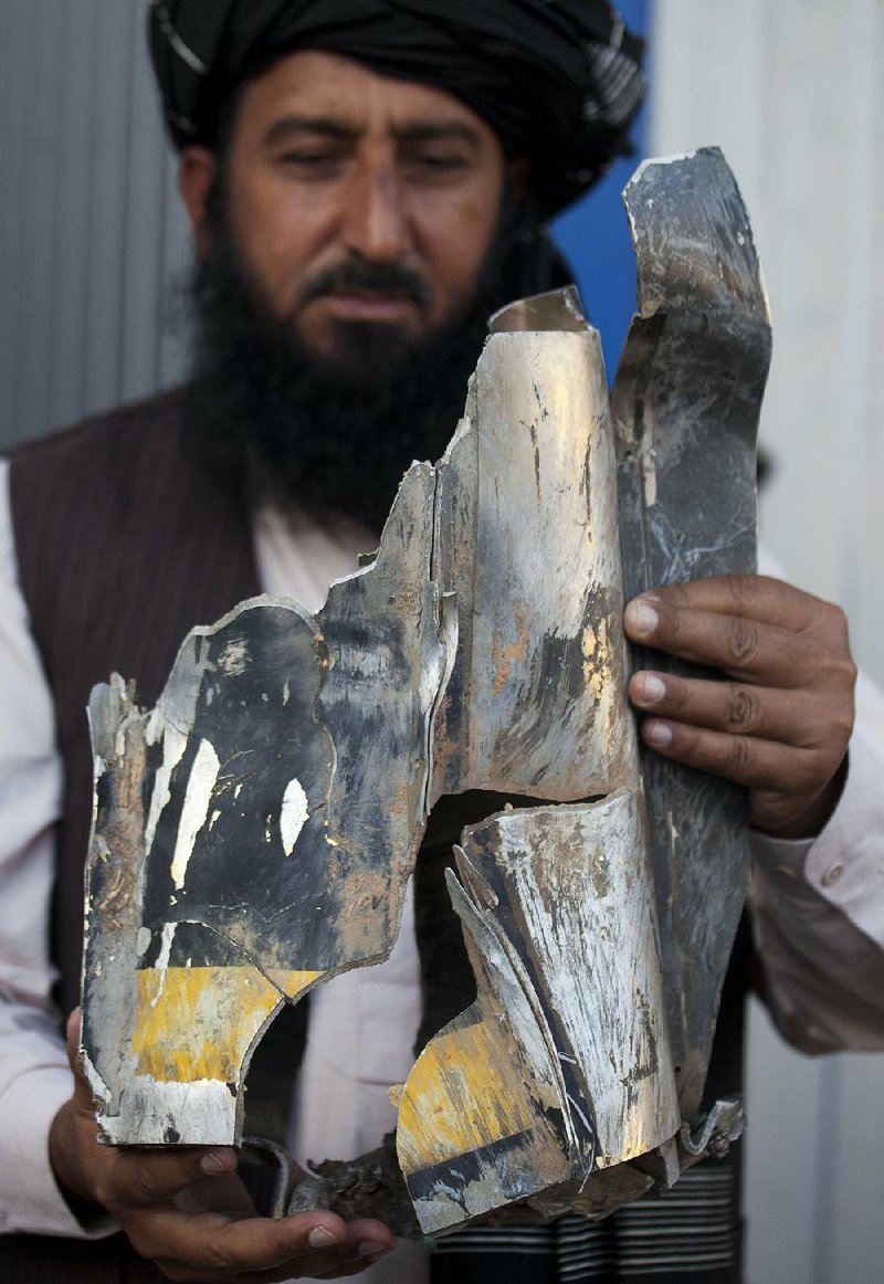 Pakistani tribal elder Karim Khan shows the remains of a missile reportedly fired by a U.S. drone on a village in north Waziristan in this Oct. 27, 2011, file photo. A Pakistani judge ordered that two Americans be charged in a 2009 drone strike that killed two people. 