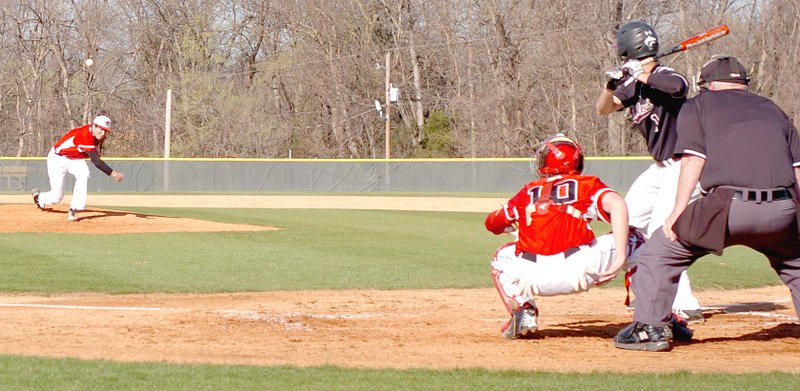 MARK HUMPHREY ENTERPRISE-LEADER Farmington starter Kelton Price delivers a pitch against Lincoln with catcher Flint Oxford on the ready. The Cardinals defeated the Wolves 14-4 on March 30.