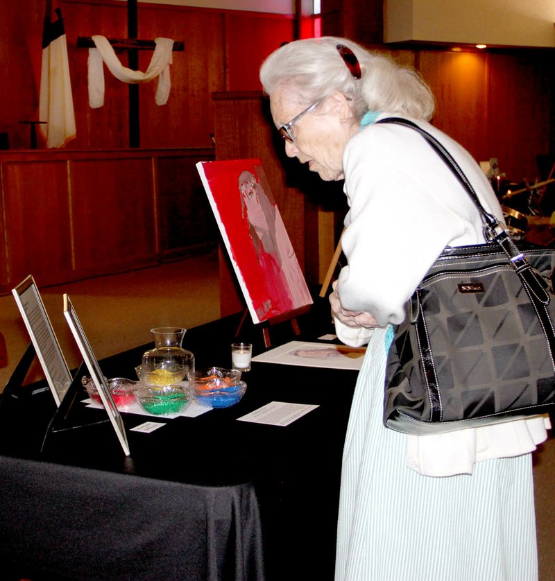 LYNN KUTTER ENTERPRISE-LEADER Virginia Harp of Farmington goes through the Stations of the Cross at Farmington First Church of the Nazarene. The stations depicted the last hours of Christ on earth before his death and burial.