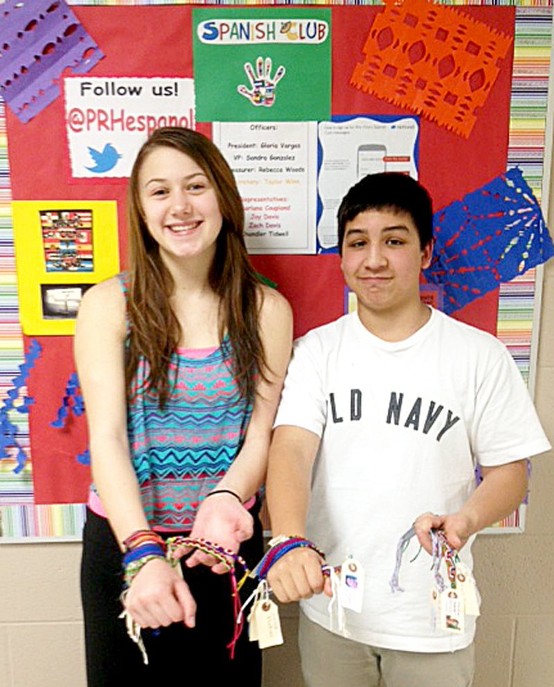 Photograph submitted Makenzie Trimble and Juan Torres, members of the Spanish Club at Pea Ridge High School, show some of the bracelet club members are selling.