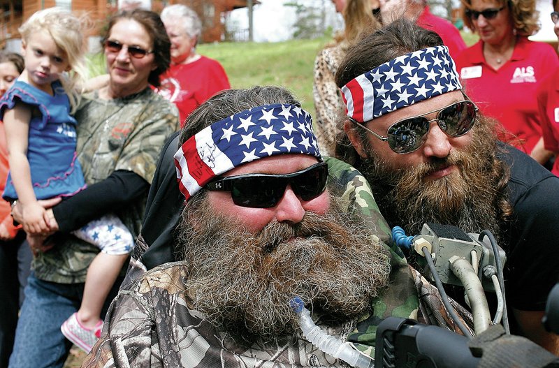 NWA Democrat-Gazette/DAVID GOTTSCHALK Steve Swope (left), 44, who was diagnosed in 2008 with ALS, poses Tuesday with Willie Robertson of the Duck Dynasty franchise at his home near Clifty. Robertson made a surprise appearance as part of the ALS Arkansas Chapter Dream to Reality program.