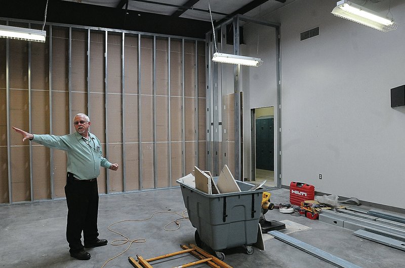 NWA Democrat-Gazette/FLIP PUTTHOFF John Sudduth, administrator of general services, shows Tuesday an area of the Benton County Jail being remodeled to house misdemeanor inmates.