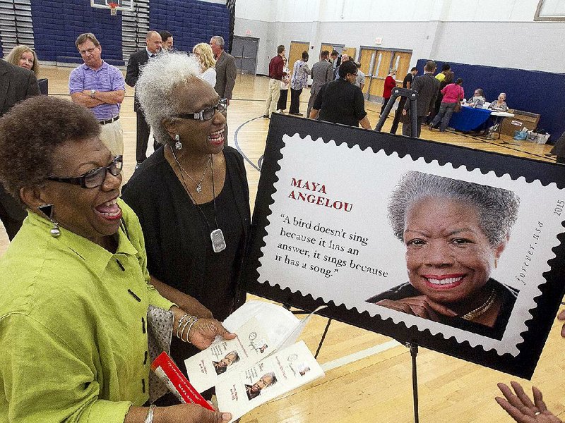 Barbara Powell-Jones (left) and Cheryl Batts of the Celebrate Maya Project admire the newly released stamp honoring Maya Angelou at a dedication ceremony Wednesday in Stamps. 