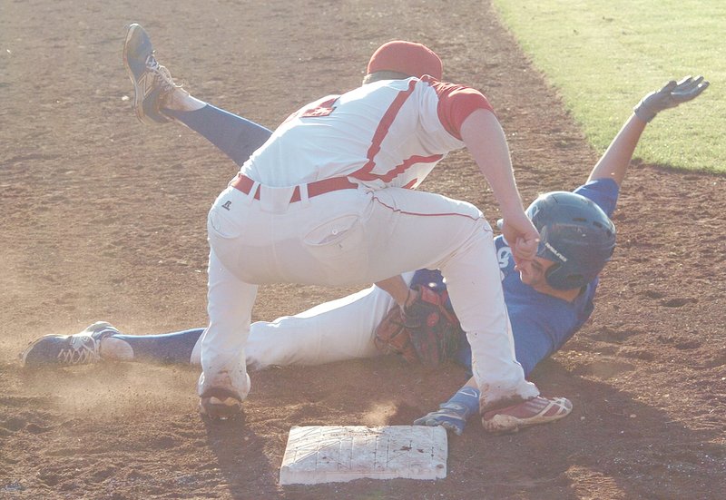 RICK PECK MCDONALD COUNTY PRESS McDonald County third baseman Jamie Hanke tags out Seneca&#8217;s Calvin Ackerson during the Mustangs 6-5 win in its 2015 home opener.