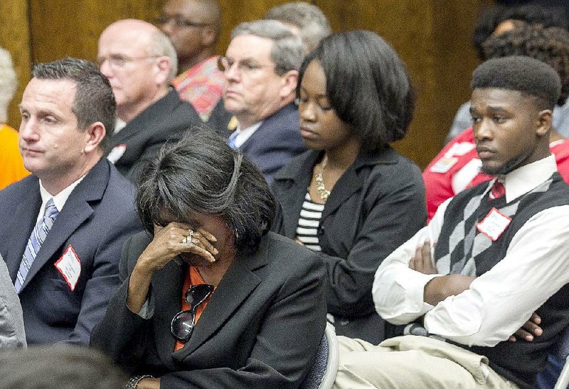 Arkansas Democrat-Gazette/BENJAMIN KRAIN --4/9/15--
Hughes School District Superintendent Sheryl Owens, center, Hughes principal Jeff Spaletta, left, and students Kendra Glasper, second from right, and Adrick Smith react in dissapointment to an Arkansas Board of Education ruling Thursday to consolidate the Hughes School District into the West Memphis School District. Arkansas law required the board to consolidate the school because its student population fell below a 350-student threshold for two years in a row at its kindergarten-through-12th-grade facility.