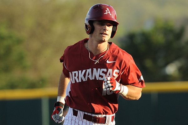 Andrew Benintendi of Arkansas rounds the bases after hitting a solo home run against Kentucky during the first inning Friday, April 10, 2015, at Baum Stadium in Fayetteville.