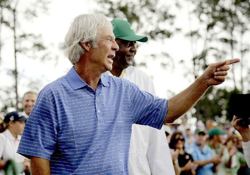 Ben Crenshaw is flanked by his longtime caddie Carl Jackson after his final round of the Masters golf tournament Friday, April 10, 2015, in Augusta, Ga.  (AP Photo/Matt Slocum)