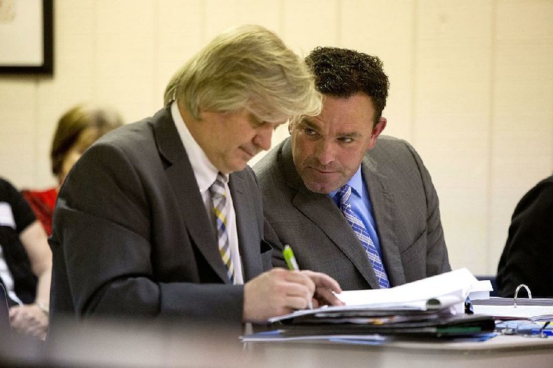 Arkansas Democrat-Gazette/MELISSA SUE GERRITS - 04/09/15 - Coach Brad Bolding, right, looks to Attorney David Couch during testimony against Bolding at his hearing regarding termination of employment April 9, 2015 at a special board meeting of the North Little Rock school board. 