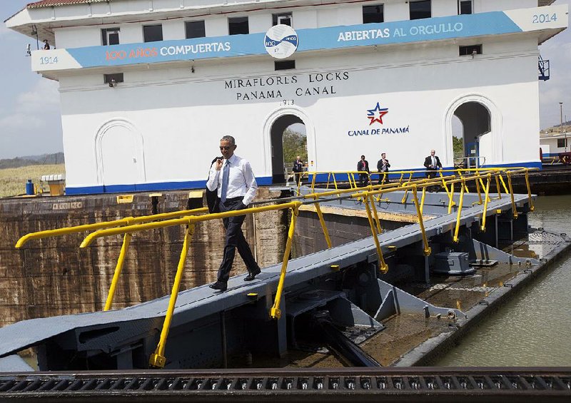 President Barack Obama walks across the Miraflores Locks during his tour of the Panama Canal in Panama City, Panama, Friday, April 10, 2015. Obama is in Panama to attend the VII Summit of the Americas. (AP Photo/Pablo Martinez Monsivais)
