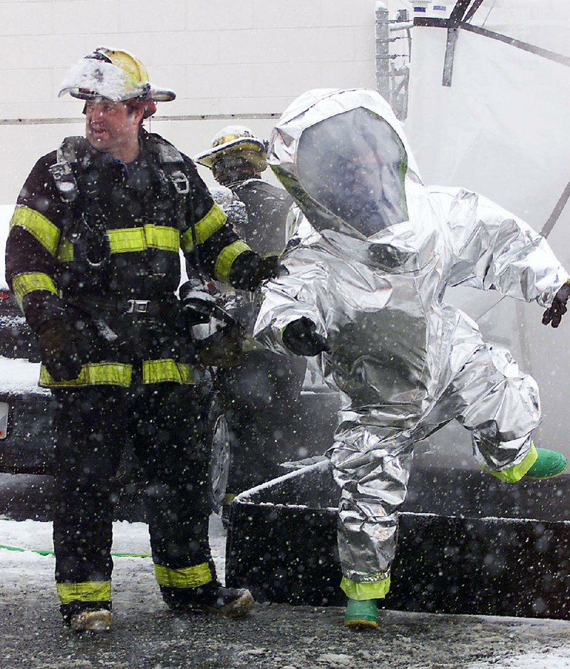 Little Rock firefighters don hazmat suits to practice pollen emergency
rescues and decontamination.