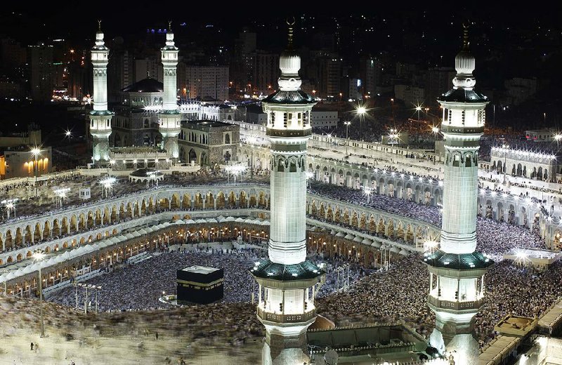 Tens of thousands of Muslim pilgrims move around the Kaaba, the black cube seen at the center, inside the Grand Mosque during an annual Hajj in Mecca.