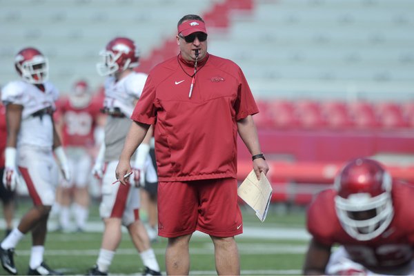 Arkansas coach Bret Bielema works with his team during practice Tuesday, April 7, 2015, at Razorback Stadium in Fayetteville.