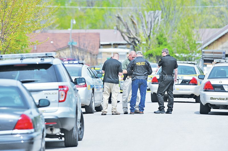 NWA Democrat-Gazette/ANDY SHUPE Springdale Police Department personnel collect information Saturday in the wake of a reported shooting on Savage Street in Springdale.