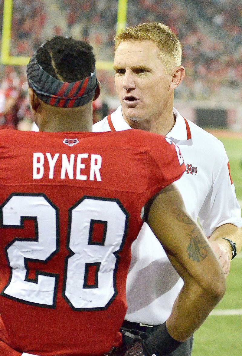 Arkansas State head coach Blake Anderson talks to running back Brandon Byner on the sidelines in this file photo.