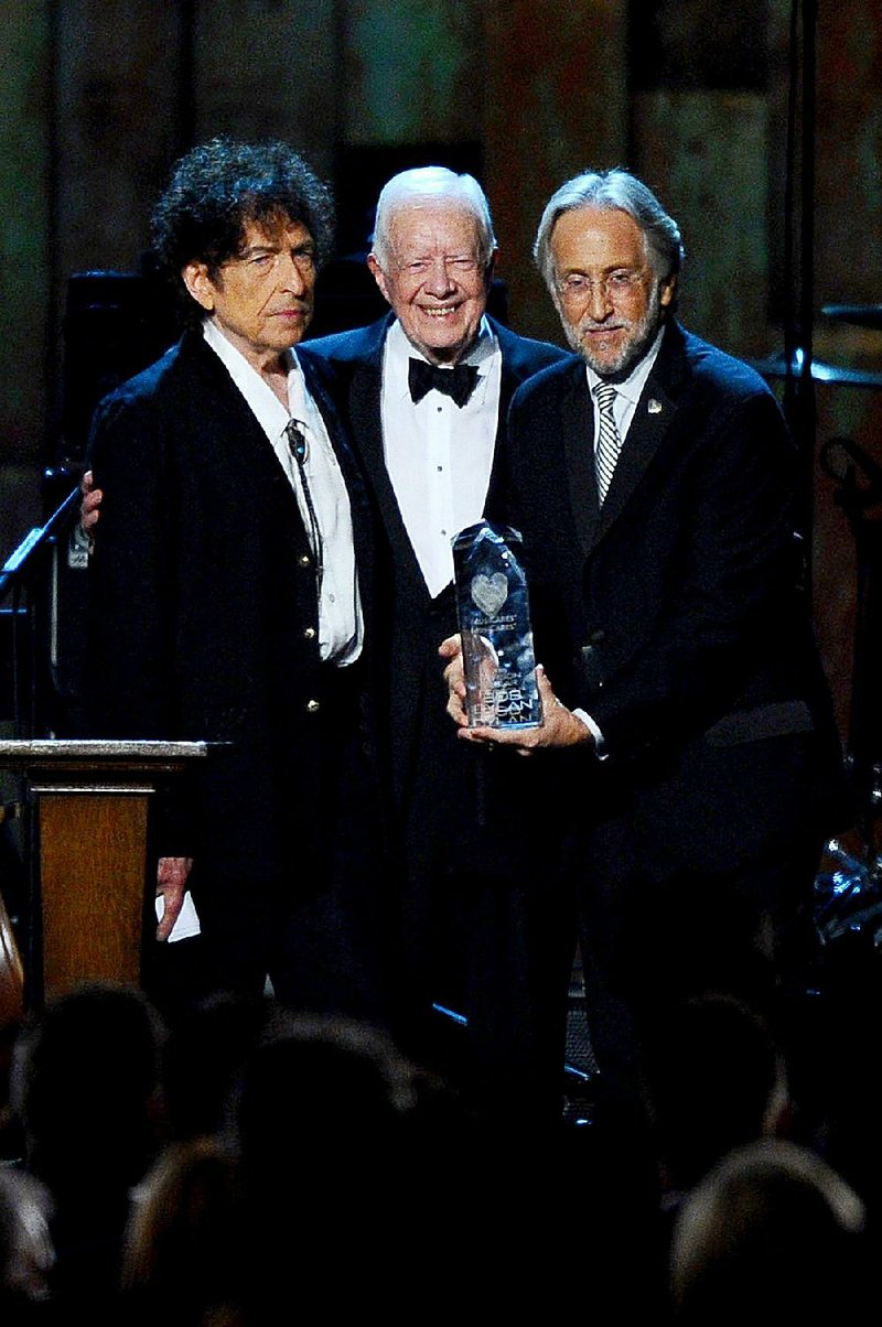 From left, President Jimmy Carter, Bob Dylan and Neal Portnow, President/CEO of The Recording Academy and President of The MusiCares Foundation, at the 2015 MusiCares Person of the Year show at the Los Angeles Convention Center on Friday, Feb. 6, 2015, in Los Angeles. 
