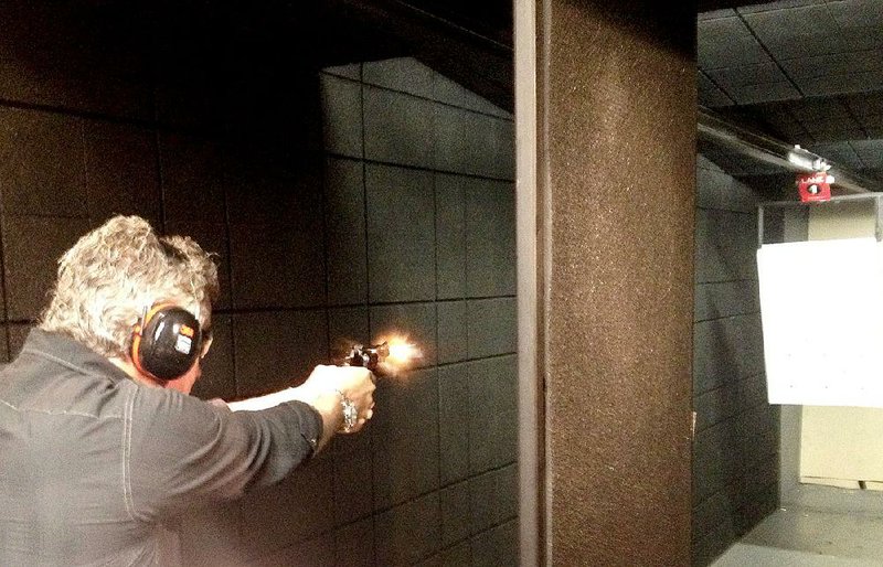 Steve Woods of Dallas fires a revolver equipped with a laser sight Tuesday at the Crimson Trace shooting range in Wilsonville, Ore. At the beginning of 2013, 15.5 percent of personal protection firearms had laser sights, according to Kent Thomas of Crimson Trace. At the end of 2014, it was 21 percent.