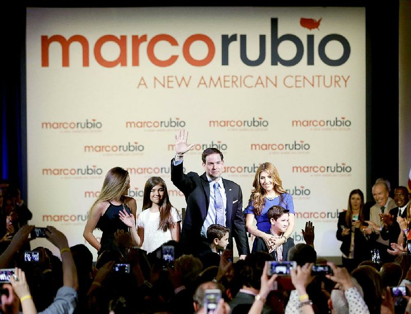 Florida Sen. Marco Rubio waves to the crowd after announcing that he will be running for the Republican presidential nomination during a rally at the Freedom Tower, Monday, April 13, 2015, in Miami. Rubio is joined by his wife Jeanette, right, and their four children, from left, Amanda, Daniella, Dominic and Anthony. (AP Photo/Wilfredo Lee)