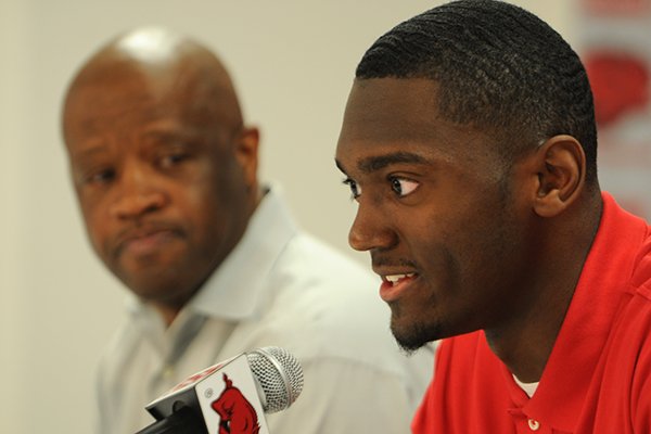 Bobby Portis, near, talks about his decision to enter the NBA Draft while Arkansas coach Mike Anderson watches on Tuesday, April 14, 2015, at Bud Walton Arena in Fayetteville. 