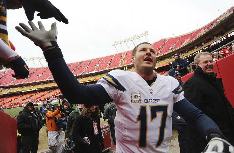 In this file photo from 2013 San Diego Chargers quarterback Philip Rivers (17) is congratulated by fans following a NFL football game.