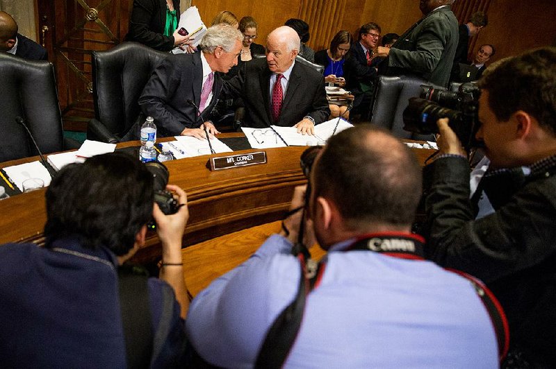 Sen. Bob Corker (left), chairman of the Senate Foreign Relations Committee, confers Tuesday with ranking member Sen. Ben Cardin during discussion of the panel’s bill on Iranian arms negotiations.