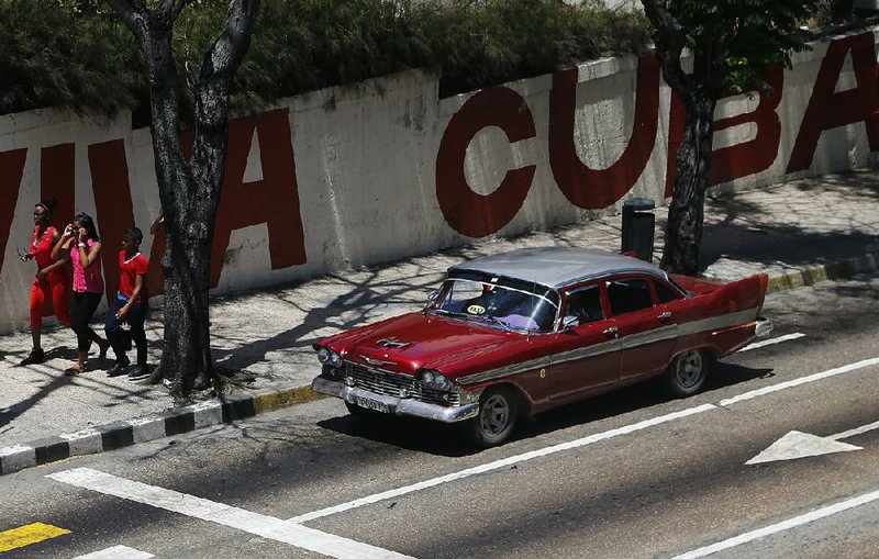 A Cuban taxi winds through a street in Havana on Tuesday. Days after a face-to-face meeting between President Barack Obama and Cuban President Raul Castro, the White House announced plans to remove Cuba from the government’s list of nations that sponsor terrorism. 