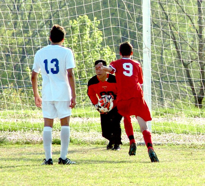 Photo by Mike Eckels Decatur goalie Meng Vang prevents a score by a Tiger player during the April 7 Decatur-Green Forest soccer match at Bulldog Stadium in Decatur. Vang was instrumental in blocking several Tiger scoring attempts, allowing the Bulldogs to take the game, 2 to 1.