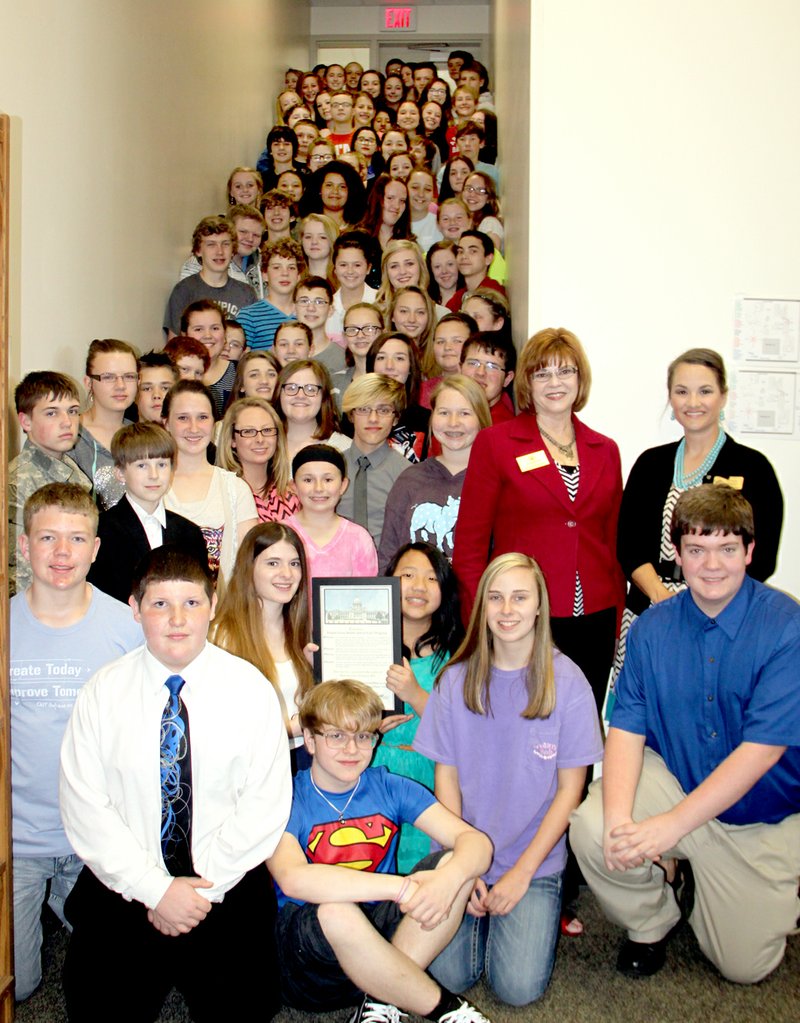 LYNN KUTTER ENTERPRISE-LEADER State Rep. Charlene Fite presented a citation from the Arkansas House of Representatives on Friday to students with Prairie Grove Middle School&#8217;s EAST program. About 100 students have been involved in EAST this year and they&#8217;ve completed around 50 projects, some small and some that involved lots of work. Standing on the right of the photo are Tracie Ashley, EAST facilitator, with Fite standing next to her. The program received a national award last month.